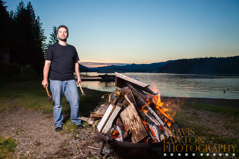 Male posing with axes and fire