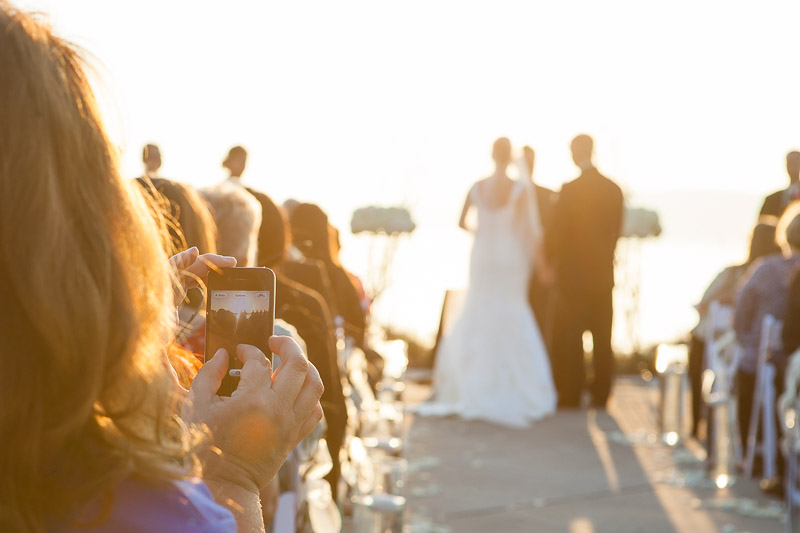 Wedding guest using phone to take a picture
